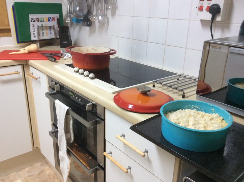 Kitchen showing cake, casserole vegetable being prepared